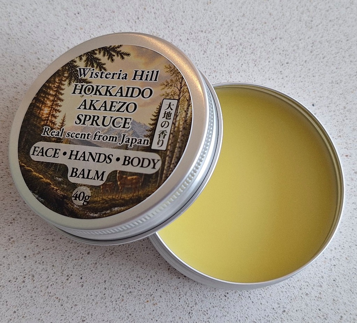 Open tin of Akaezo Spruce botanical balm