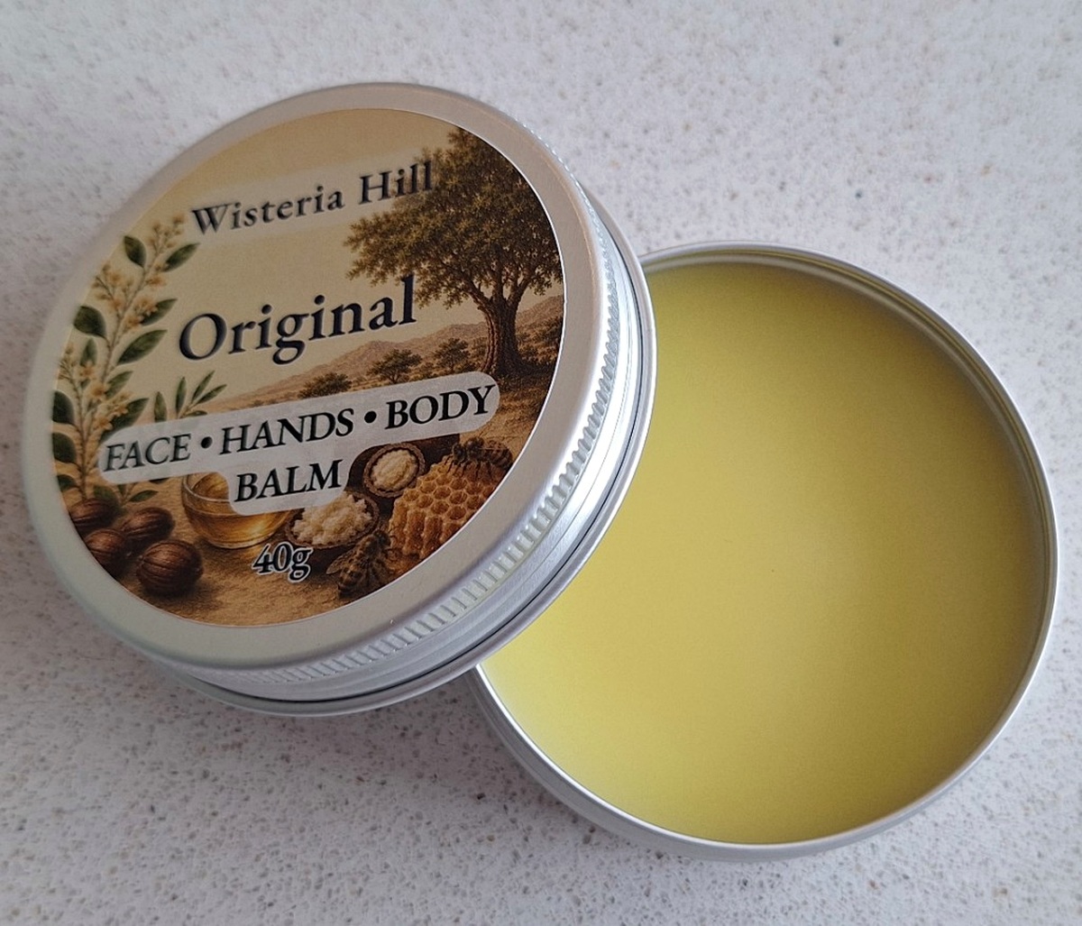 Open tin of Original unscented botanical balm